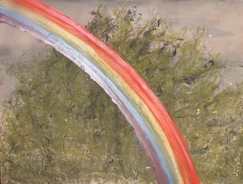 rainbow poppin' right in your face against a cypress tree and grey after-storm sky